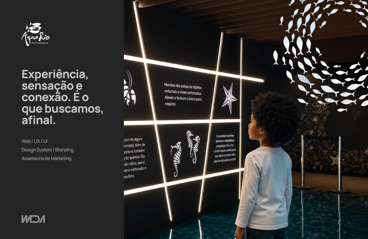 A child in front of AquaRio's educational signage panel.