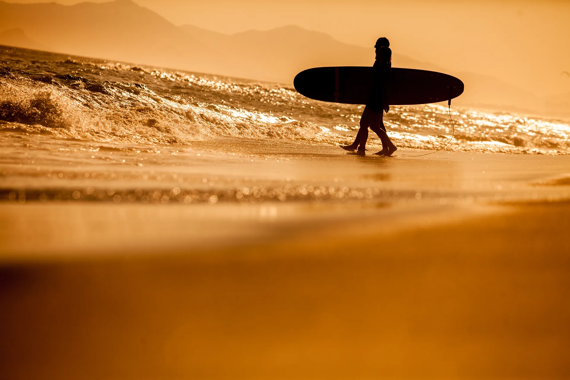 Classico Beach Club: surfista caminhando para o mar.